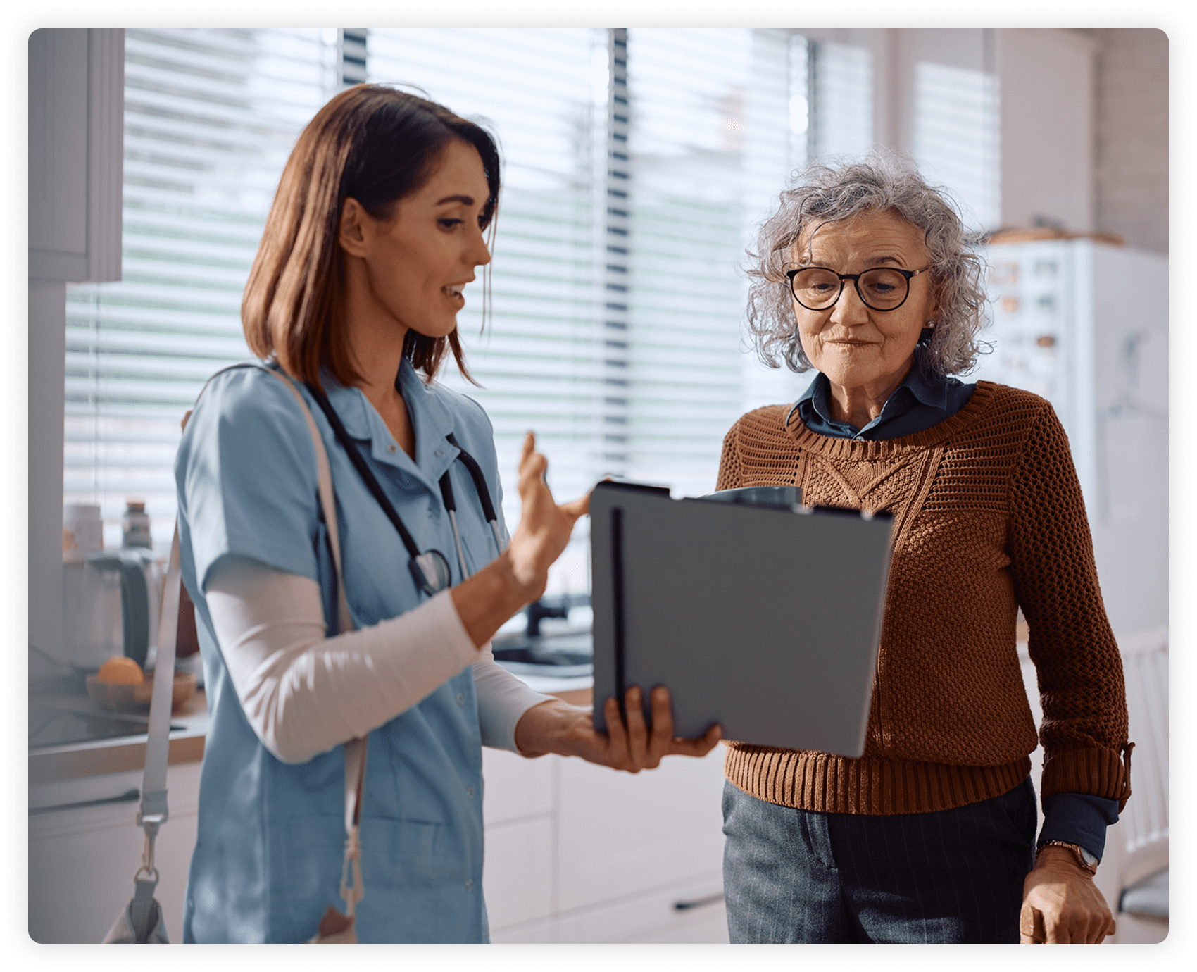 Nurse explaining medical chart to elderly woman