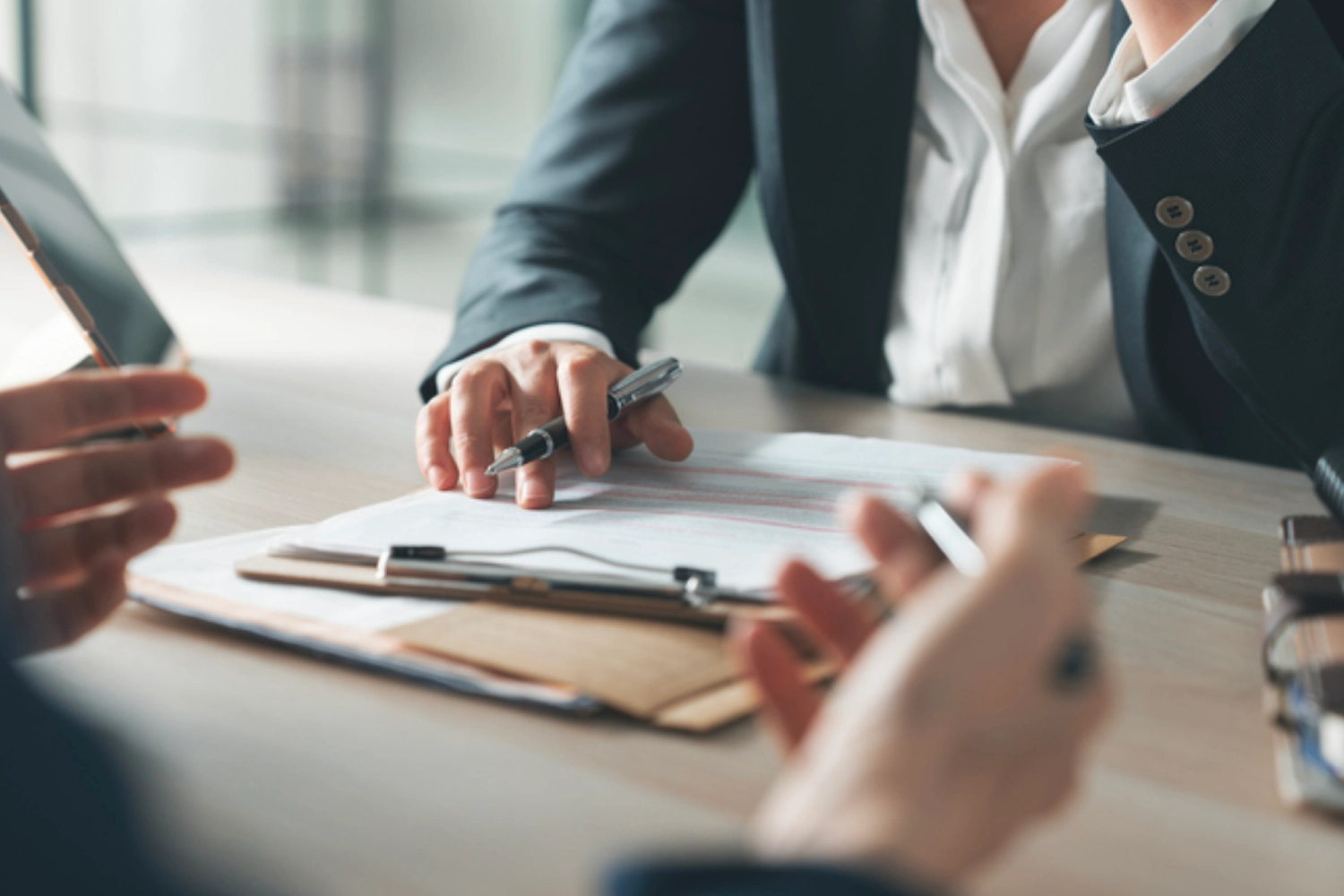 Two professionals reviewing documents during a business meeting.